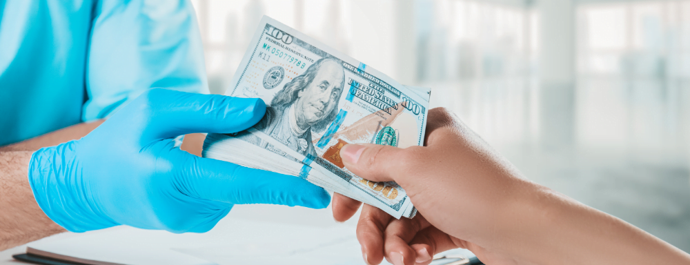 Patient giving money to doctor | Get Financing help at Dr. Leonard Grossman M.D. | New York