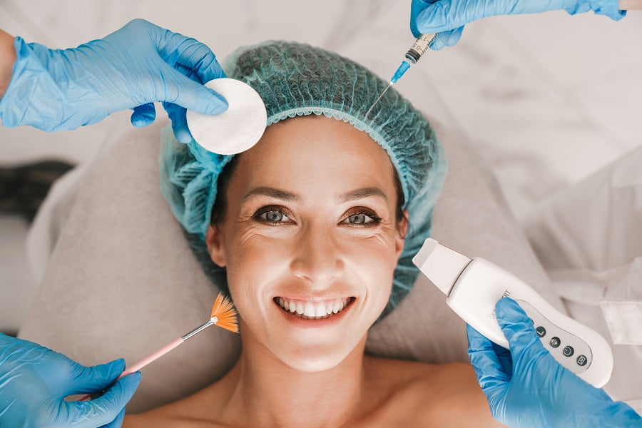 Happy smiling woman getting beauty treatment | Get Cosmetic surgery at Dr. Leonard Grossman M.D. | New York